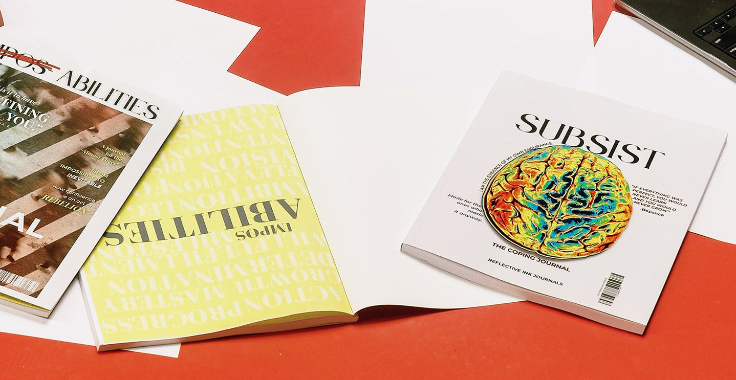 Open book with 'Impos-Abilities' cover, yellow notebook, and 'Subsist' magazine on a red and white background
